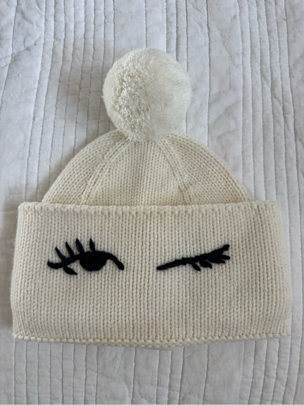kate spade Cream Knit Pom Beanie with Black Wink Motif - Accessories